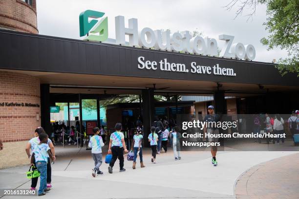 Children make a line to enter the Houston Zoo, Tuesday, April 26 in Houston.