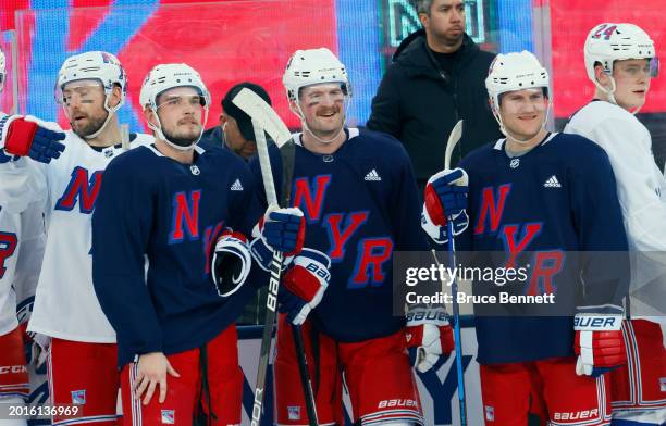 Ryan Lindgren, Alexis Lafreniere and Adam Fox practice ahead of their Stadium Series game at MetLife Stadium on February 16, 2024 in East Rutherford,...