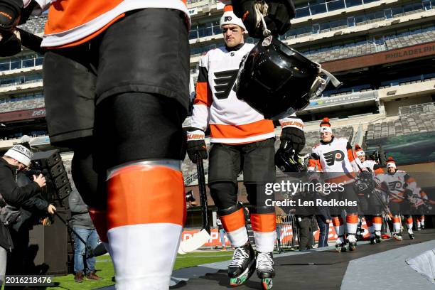 Travis Sanheim of the Philadelphia Flyers and his teammates make their way to the ice for a team photo before practice at MetLife Stadium on February...