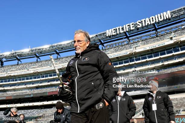 Head Coach John Tortorella of the Philadelphia Flyers makes his way to the ice surface for a team photo before practice at MetLife Stadium on...