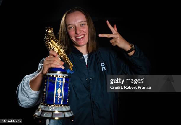 Iga Swiatek of Poland poses with the champions trophy after defeating Elena Rybakina of Kazakhstan in the singles final on Day 7 of the Qatar...