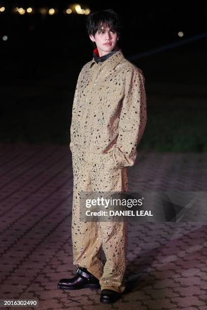 Thai actor Bright Vachirawit arrives to attend the catwalk presentation for British fashion house Burberry's Autumn/Winter 2024 collection, at London...