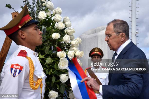 Picture released by Cuban News Agency showing Russian Foreign Minister Serguei Lavrov placing a wreath on the Jose Marti Mausoleum in Havana on...