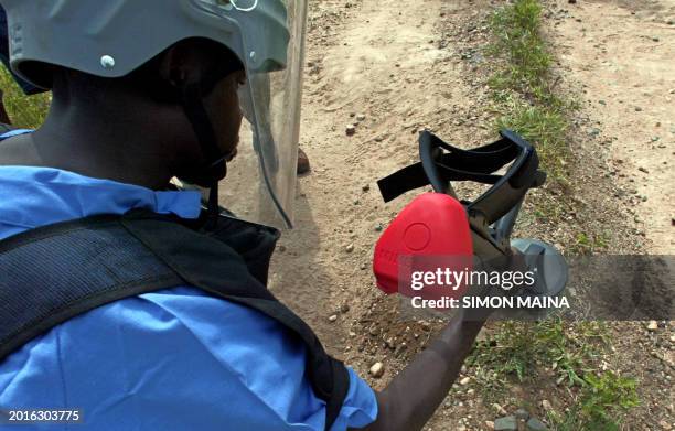 File photo taken 09 August 2005 shows a Sudanese deminer working for South African demining team Mechem, using a metal detector on a road linking the...