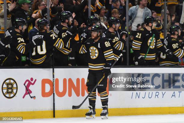 David Pastrnak of the Boston Bruins celebrates his third-period goal against the Dallas Stars at the TD Garden on February 19, 2024 in Boston,...