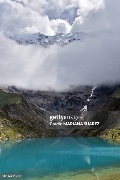 Partial view of Humantay Lake and Humantay Mount seen through clouds, in the Vilcabamba mountain range, part of the Peruvian Andes, near Mollepata...