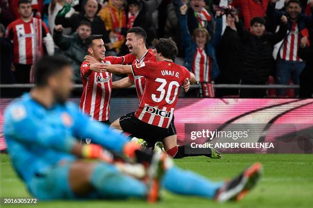 Athletic Bilbao's Spanish forward Alex Berenguer celebrates with teammates after scoring his team's second goal during the Spanish league football...