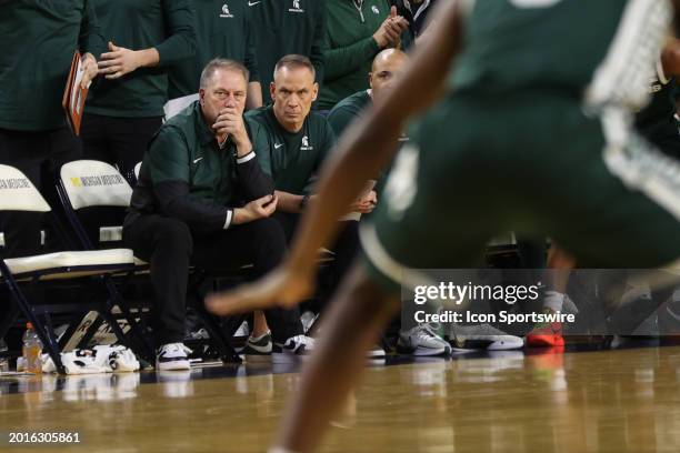 Michigan State Spartans head coach Tom Izzo, center, watches the action on the court during a regular season Big Ten Conference college basketball...