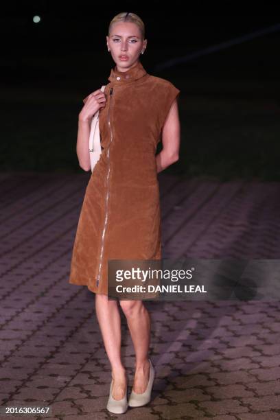 British model Iris Law arrives to attend the catwalk presentation for British fashion house Burberry's Autumn/Winter 2024 collection, at London...