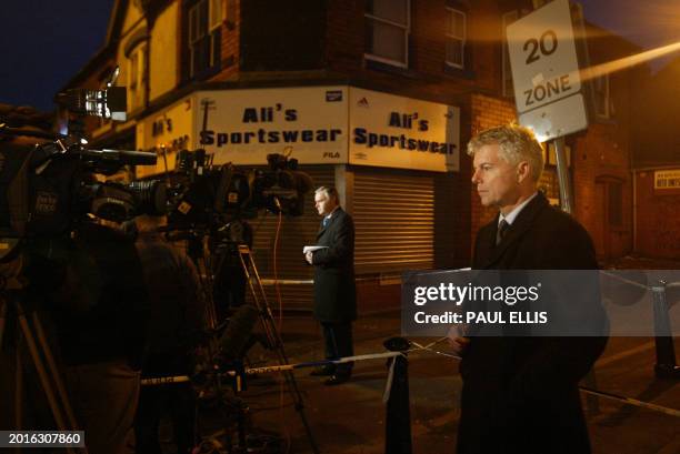 British television crew present a news bulletin from the end of Jackson Street in Birmingham, central England, 31 January 2007 after a raid in the...