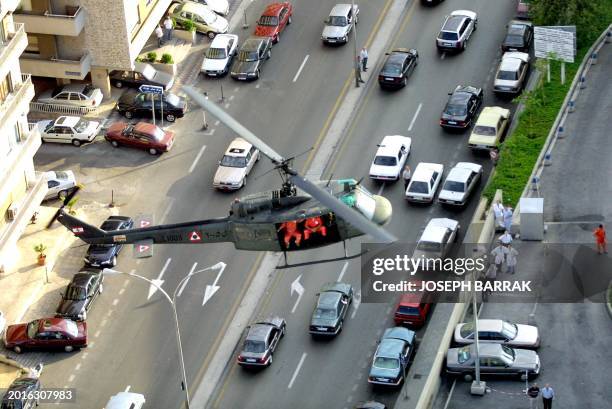 Helicopter carries civil defence workers prior to its landing on the roof of the Hotel Dieu De France hospital during a Lebanese army anti-terrorism...