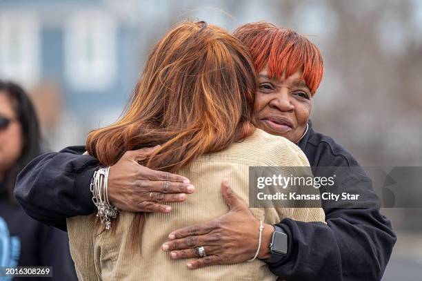 Rosilyn Temple, founder of the Kansas City chapter of Mothers in Charge, shares a hug with a community member during a vigil to remember the victims...