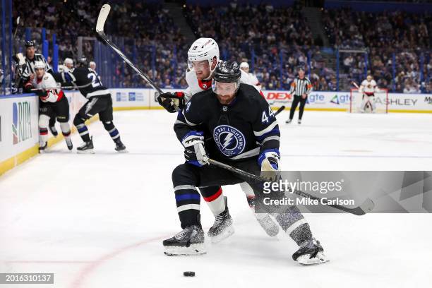 Drake Batherson of the Ottawa Senators checks Darren Raddysh of the Tampa Bay Lightning during the first period of the game at the Amalie Arena on...