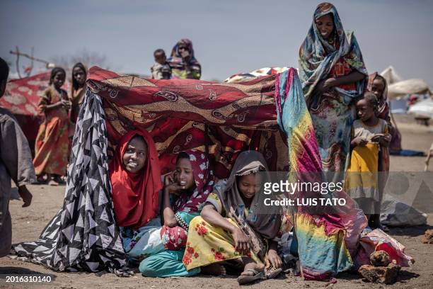 Sudanese girls who have fled from the war in Sudan gather under a shade at a Transit Centre for refugees in Renk, on February 15, 2024.More than...