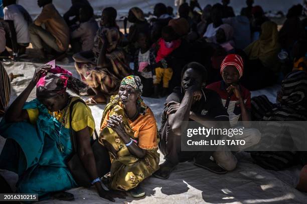 South Sudanese returnees who have fled from the war in Sudan line up during a cash assistance programme at a Transit Centre for refugees in Renk, on...