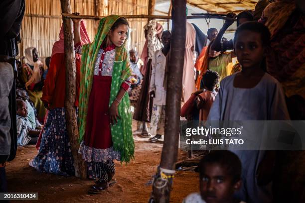 Sudanese girl who have fled from the war in Sudan with her family stands after crossing the border while waiting to be registered by the authorities...