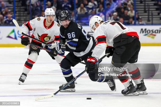 Nikita Kucherov of the Tampa Bay Lightning skates past Brady Tkachuk of the Ottawa Senators during the second period of the game at the Amalie Arena...