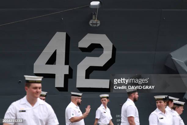 Sailors from the Royal Australian Navy stand in front of the Australian Navy destroyer HMAS Sydney in Sydney on February 20, 2024.
