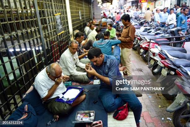 This photograph taken on February 7, 2024 shows diamond traders gathered at the main market in Surat. Man-made gems are reshaping the $89 billion...