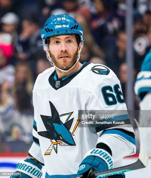 Mike Hoffman of the San Jose Sharks looks on during a second period stoppage of play against the Winnipeg Jets at Canada Life Centre on February 14,...