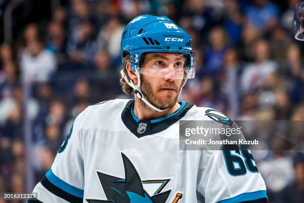 Mike Hoffman of the San Jose Sharks looks on during a second period stoppage of play against the Winnipeg Jets at Canada Life Centre on February 14,...