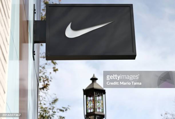 The Nike logo is displayed at a Nike Well Collective store on February 16, 2024 in Glendale, California. Nike announced it will be laying off 2...