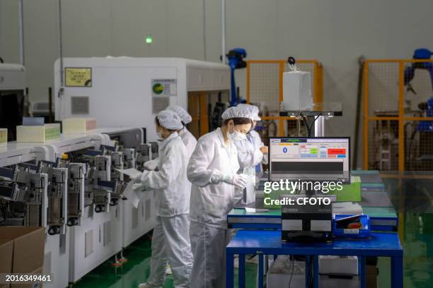 Workers produce photovoltaic silicon wafers at a workshop of a photovoltaic silicon wafer company in Hefei circular Economy Demonstration Park in...