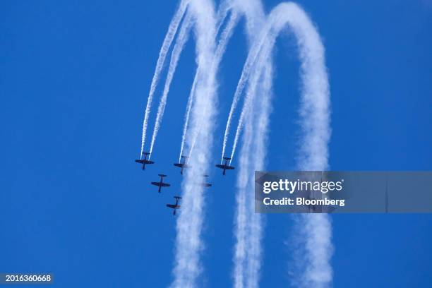 The Royal Australian Air Force Roulettes performs maneuvers in Pilatus Flugzeugwerke AG PC-9 aircraft during an aerobatic flying display during the...