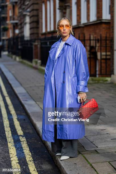 Charlotte Collins wears oversized purple coat, red Chanel bag outside Bora Aksu during London Fashion Week February 2024 on February 16, 2024 in...