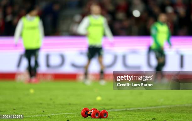 Toy car thrown onto the pitch by fans are seen during the Bundesliga match between 1. FC Köln and SV Werder Bremen at RheinEnergieStadion on February...