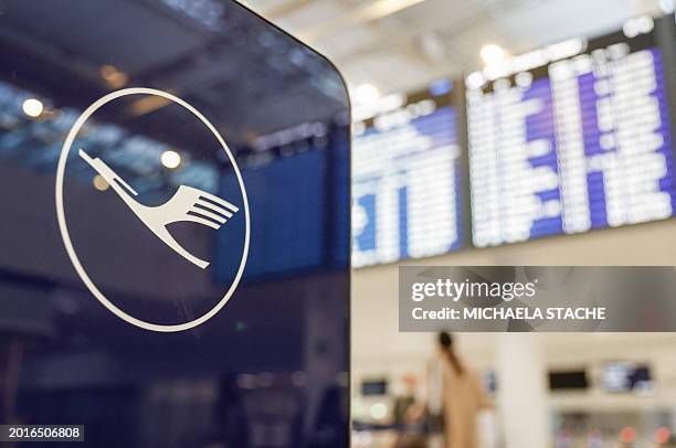 Le logo of German airline Lufthansa is seen next to the almost empty check-in area during a strike action by ground crews, services staff and...