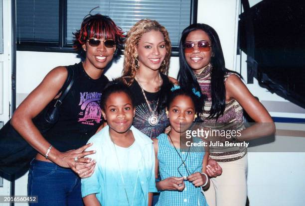 Singers Beyoncé Knowles, Kelly Rowland, & Michelle Williams of Destiny's Child pose with young fans in Orlando, Florida, on April 1, 2001.