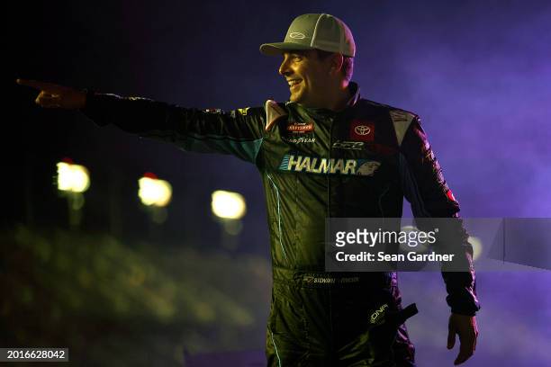 Stewart Friesen, driver of the Halmar International Toyota, waves to fans as he walks onstage during driver intros prior to the NASCAR Craftsman...