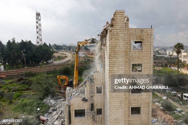 Israeli military excavators demolish the house of the Palestinian Abu Zahra family, which was reportedly built without a construction permit, in the...