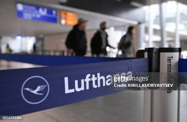 Passengers stand in the check-in area of German airline Lufthansa during a strike action by ground crews, services staff and security personnel, at...