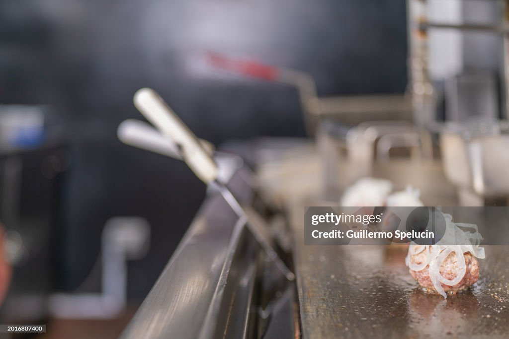 Frying ground beef with onions on the griddle