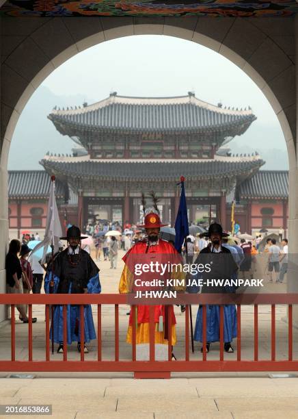 Traditional Korean gatekeepers stand at the Gwanghwa Gate, the main gate to royal Gyeongbok Palace, in Seoul on August 16, 2010. The palace is the...