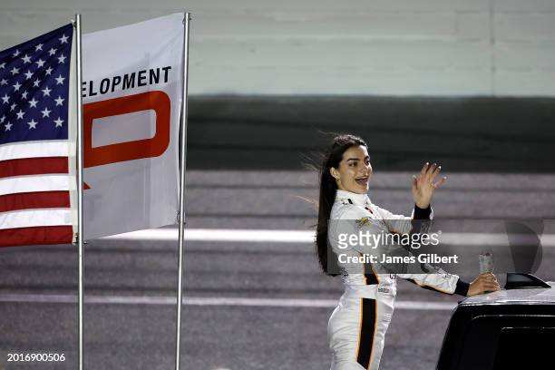 Toni Breidinger, driver of the Celsius Toyota, waves to fans during the parade lap prior to the NASCAR Craftsman Truck Series Fresh from Florida 250...