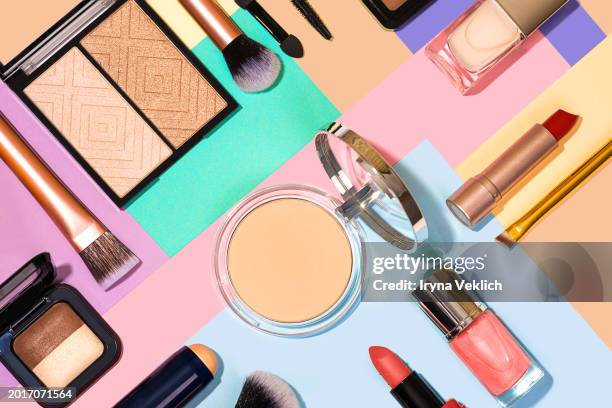 collection of beauty cosmetic products  on a multi-color background. cosmetic make-up  products for a woman  - make-up brush, lipstick, face powder blush palette, eyeshadow, mascara, highlighter, nail polish on pastel colours papers background. - aqua nail polish stock pictures, royalty-free photos & images