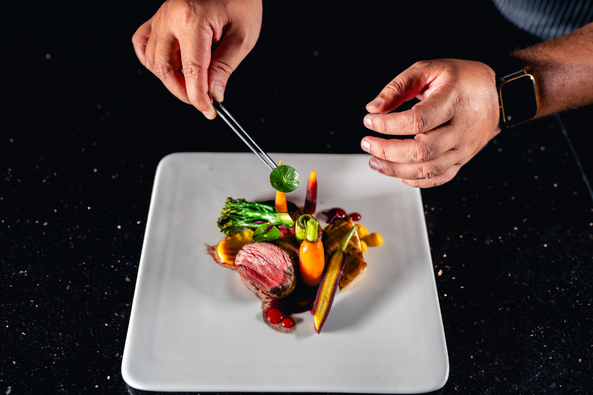 Chef is finishing the preparation of the plate Chef is finishing the preparation of the plate