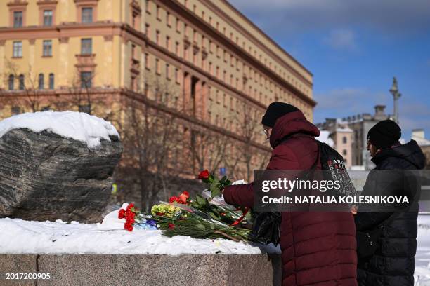 People come to lay flowers for late Russian opposition leader Alexei Navalny at the Solovetsky Stone, a monument to political repression that has...