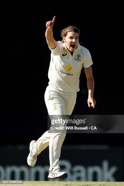 Annabel Sutherland of Australia celebrates after taking the wicket of Chloe Tryon of South Africa during day three of the Women's Test Match between...