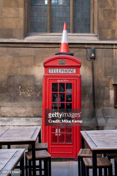 Traffic cone on top of a red telephone box on 18th January 2024 in London, United Kingdom.