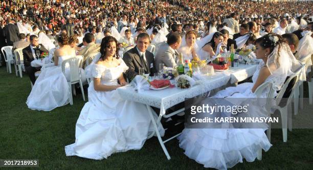 Karabakh-Armenian couples participate on October 16, 2008 in a mass wedding celebration in Shusha. More than 750 couples from the Nogorny-Karabakh...