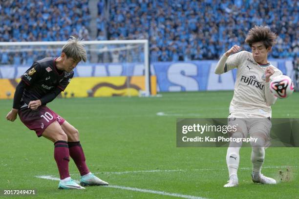 Yuya Osako of Vissel Kobe crosses the ball under the pressure from Tatsuki Seko of Kawasaki Frontale during the FUJIFLIM SUPER CUP match between...