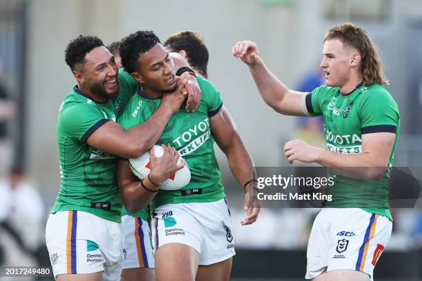 Peter Hola of the Raiders celebrates with team mates after scoring a try during the NRL Pre-season challenge match between Parramatta Eels and...