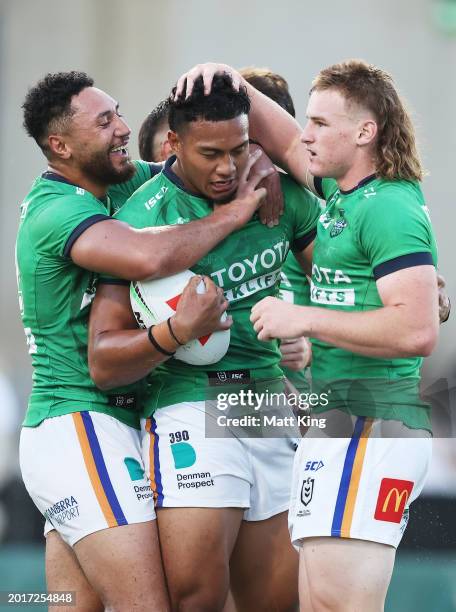 Peter Hola of the Raiders celebrates with team mates after scoring a try during the NRL Pre-season challenge match between Parramatta Eels and...