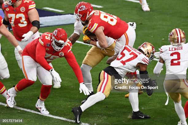 Travis Kelce of the Kansas City Chiefs runs with the ball against the San Francisco 49ers in the first half during Super Bowl LVIII at Allegiant...