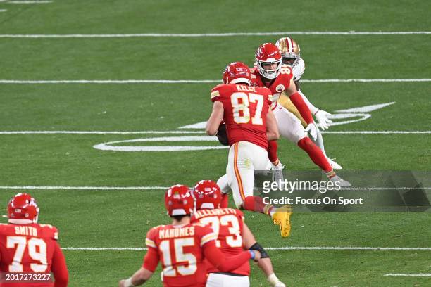Travis Kelce of the Kansas City Chiefs runs with the ball against the San Francisco 49ers in overtime during Super Bowl LVIII at Allegiant Stadium on...