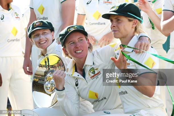 Alyssa Healy, Beth Mooney and Sophie Molineux of Australia celebrate victory during day three of the Women's Test Match between Australia and South...